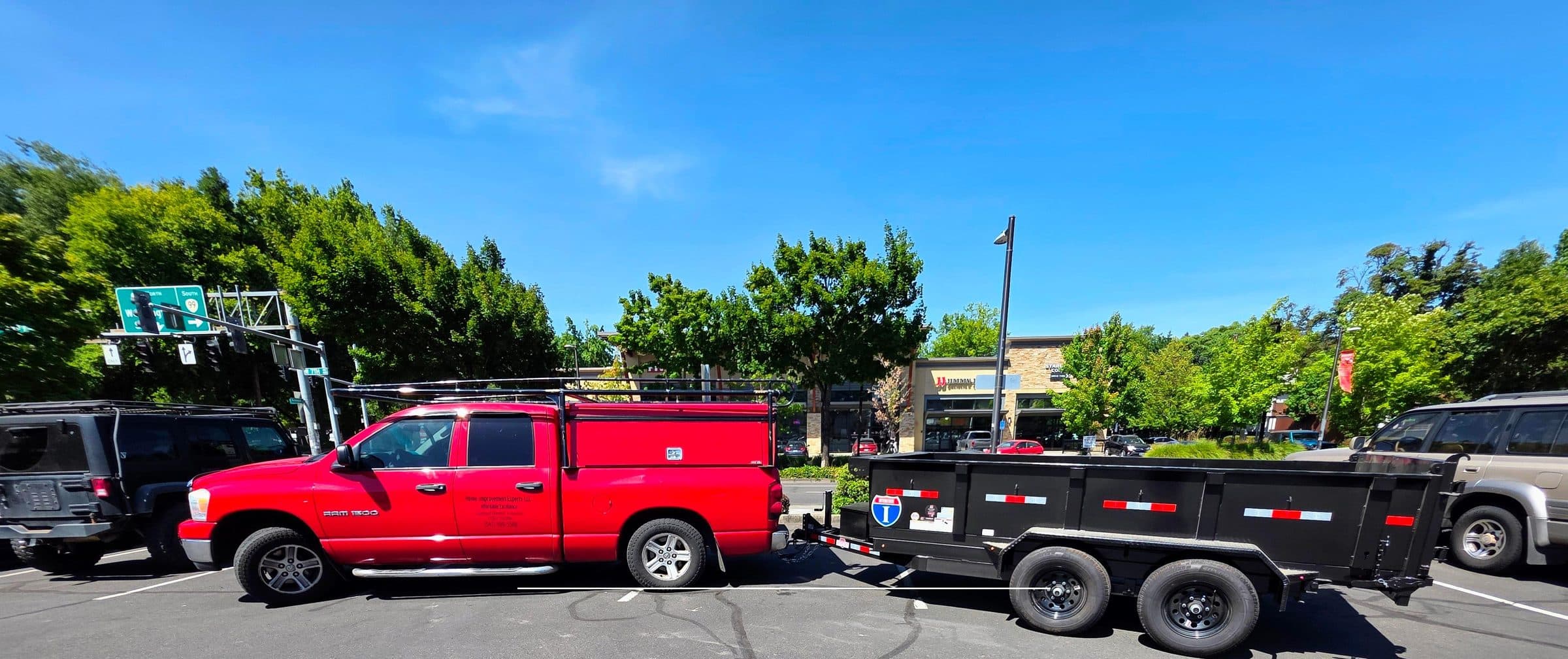Florence Junk Removal's red pickup truck towing a black dump trailer